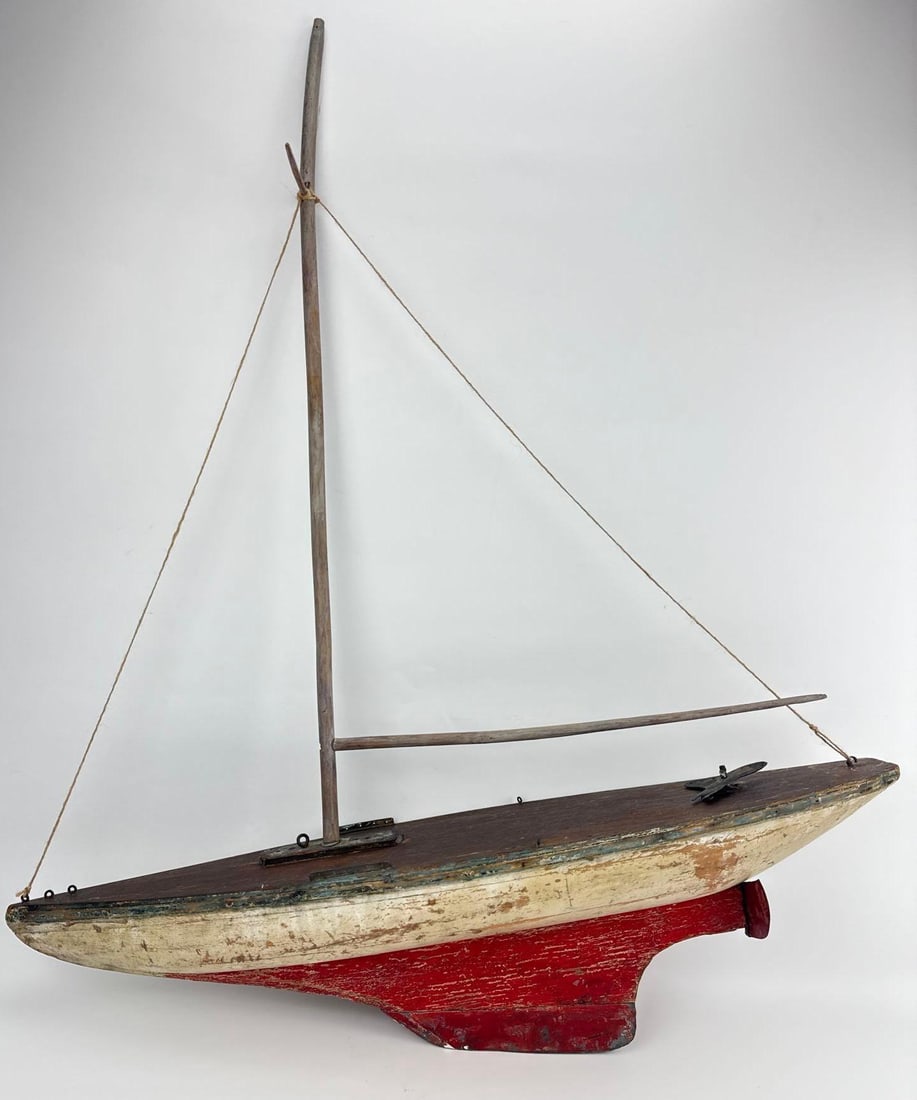 VINTAGE HAND-CARVED WOODEN POND YACHT SAILBOAT MODEL: A vintage, folk-art style wooden pond yacht or sailboat model display piece. Approximate Dimensions: 37.5”h x 30”w x 7”d Artist or Maker: Unknown Provenance: From a