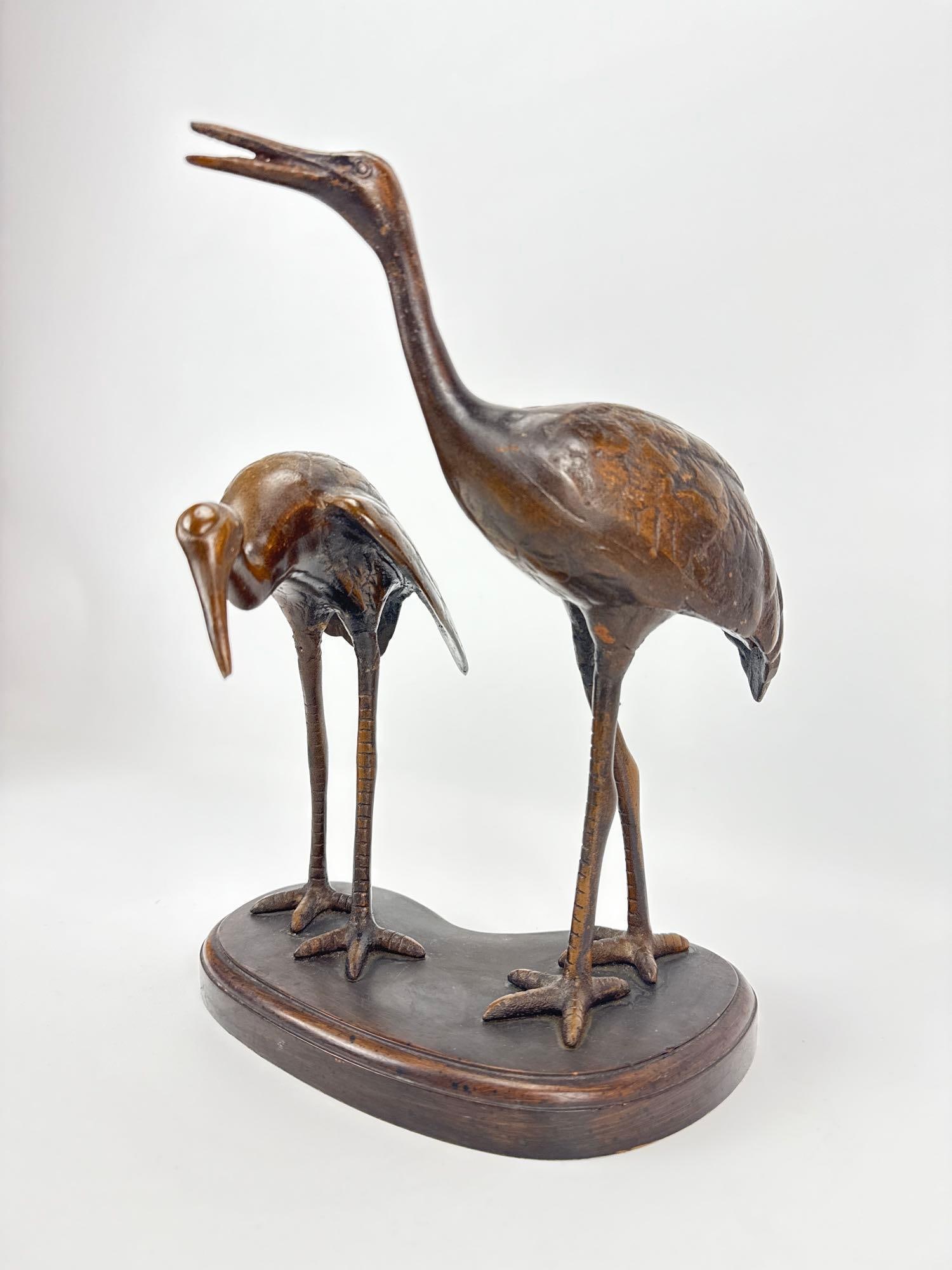 PAIR OF BRONZE-CLAD ASIAN CRANE FIGURINES: *Detailed decorative sculpture featuring two stylized birds. Approximate Dimensions:12.5”h x 9.5”w x 8.5”h Artist or Maker: Unknown Provenance: From a New York