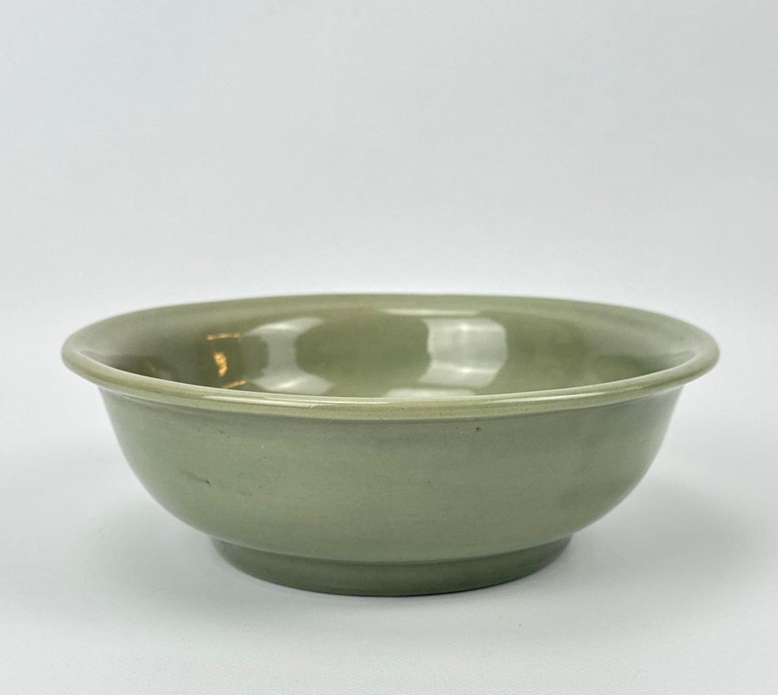 ANTIQUE CHINESE CELADON POTTERY BOWL WITH INCISED FLORAL PATTERN: A celadon glazed pottery bowl with subtle interior incised floral motif. Approximate Dimensions: 2.25”H x 7”Dia Artist or Maker: Unknown Provenance: From a Bridgehampton private collection