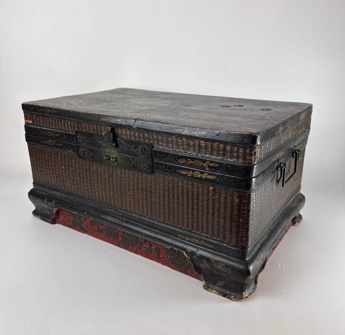 ANTIQUE CHINESE WOVEN RATTAN AND LACQUERED WEDDING TRUNK / CHEST: *Mixed media storage chest with tightly woven rattan panels, gilt lacquer borders, and cinnabar-style carved base. Approximate Dimensions: 11” x 18” x 9.5” h Artist or Maker: Unknown