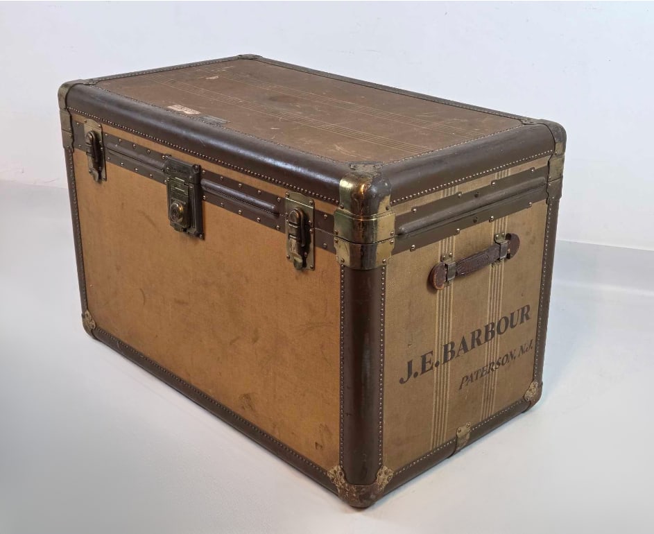 HARTMANN VINTAGE CANVAS AND LEATHER BINDING STEAMER STORAGE TRUNK: Large rectangular travel trunk in signature tan canvas with reinforced leather edging, brass hardware, and a spacious fabric-lined interior for home storage or decor. Approximate Dimensions: 25"H 