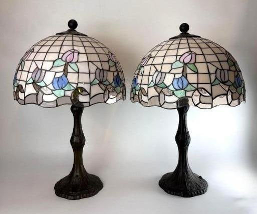PATINATED METAL TIFFANY-STYLE LAMPS: *Two matching table lamps with stained glass dome shades in a floral tulip motif on decorative metal bases. Approximate Dimensions: 23”H x 14”Dia Artist or Maker: Unknown Provenance: From