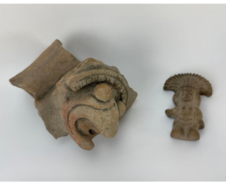 PAIR OF ANTIQUE PRE-COLUMBIAN TERRACOTTA POTTERY FRAGMENTS: Two ancient Pre-Columbian molded clay pieces containing a larger stylized zoomorphic figure or vessel handle shard and a smaller flat idol figurine with a fan-shaped headdress. Approximate Dimensions: