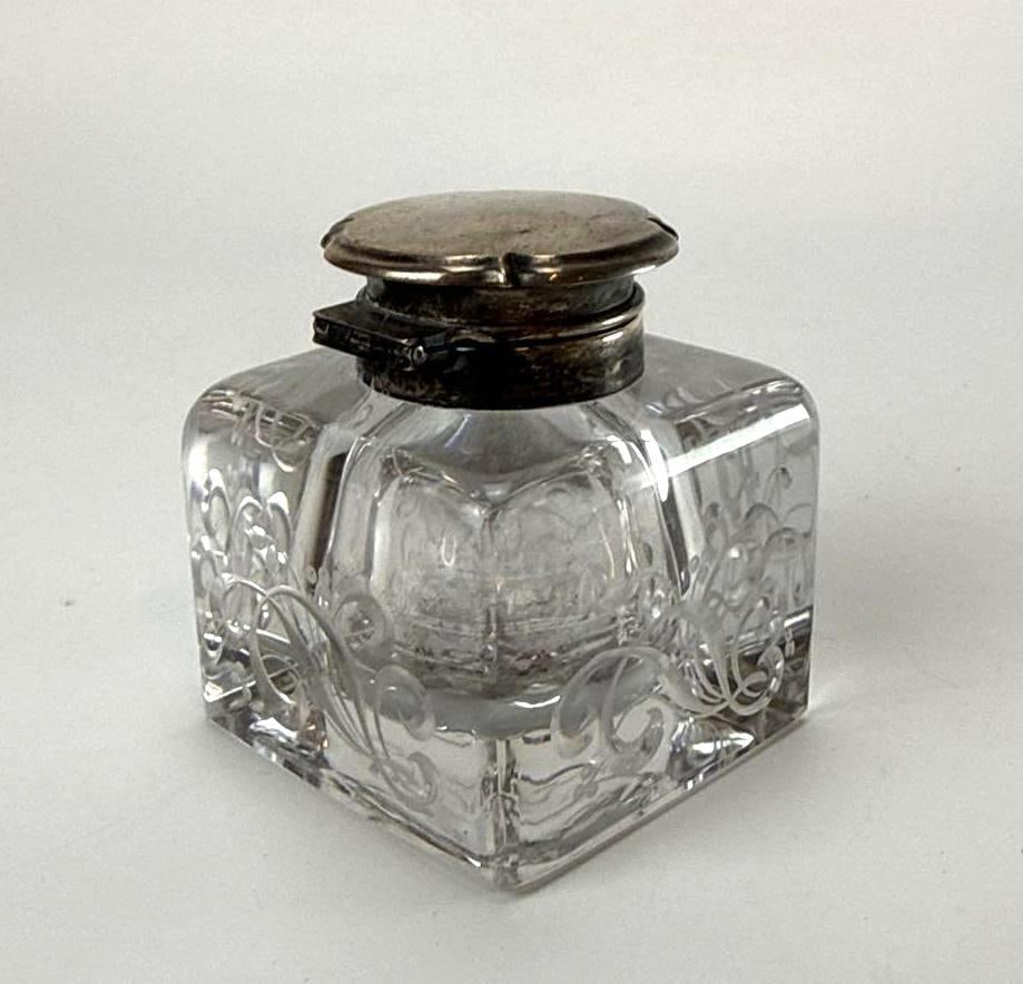 GORHAM STERLING SILVER MOUNTED CUT GLASS SQUARE DESK INKWELL: Antique American brilliant period cut glass square desk inkwell adorned with an etched flowing foliate scrollwork motif and topped with a hinged sterling silver collar and lid by Gorham Manufacturing 