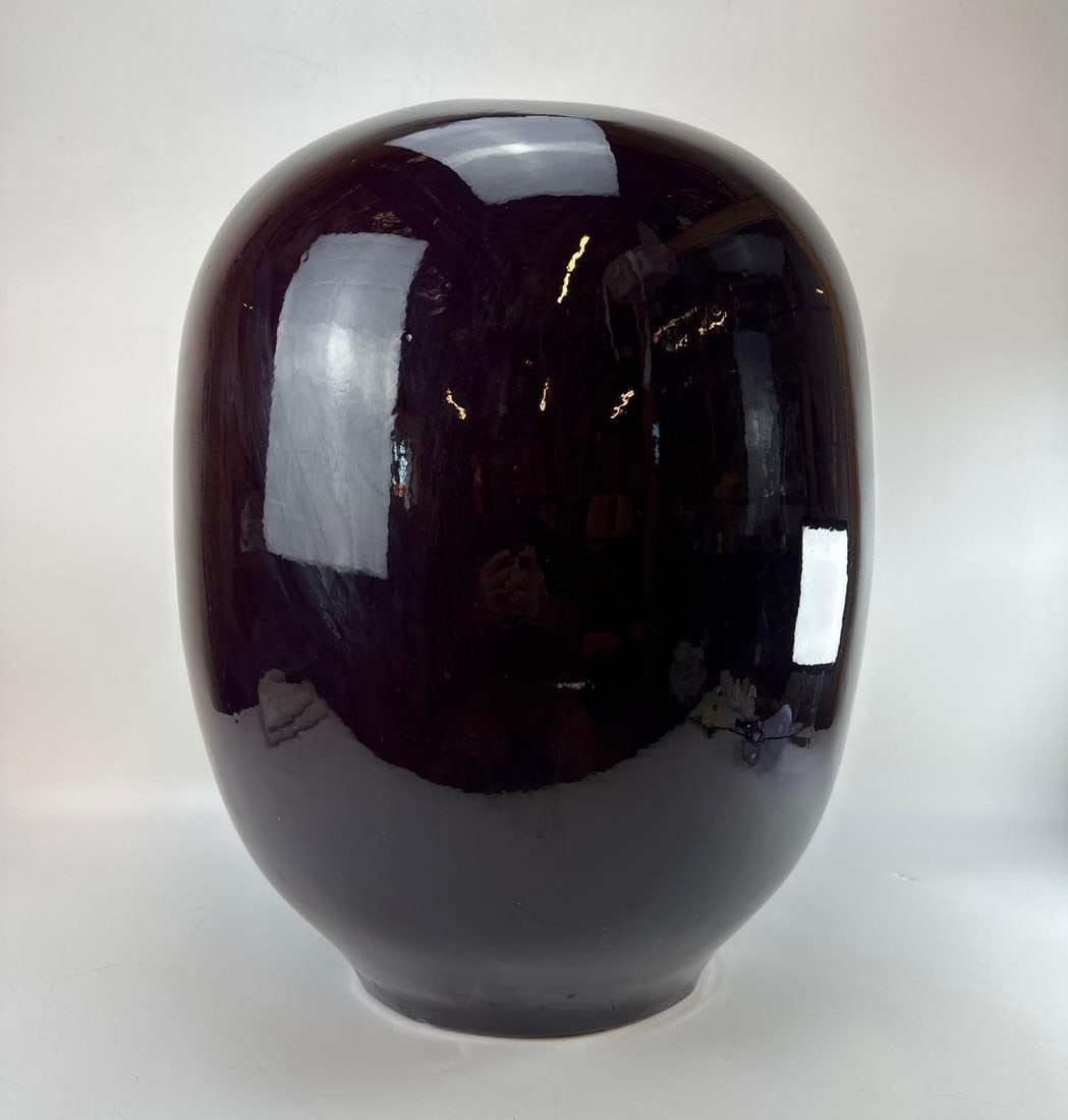 LARGE OXBLOOD GLASS VASE WITH HAIRLINE CRACK AT RIM: Large Glass Vase (note loss in photo) Approximate Dimensions:17”diameter x 22”high Artist or Maker: Unknown Provenance: From a New York Collector <