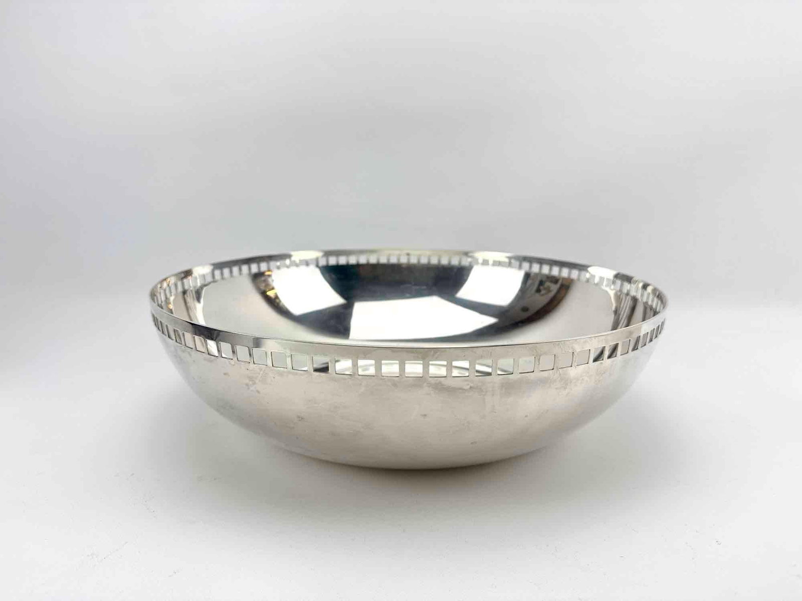 RICHARD MEIER FOR SWID POWELL POSTMODERN SILVER PLATED SKYSCRAPER CENTERPIECE BOWL: Large vintage modernist silver-plated metal centerpiece bowl designed by architect Richard Meier with a distinctive geometric grid cutout pattern along the upper rim perimeter. Approximate Dimensions: