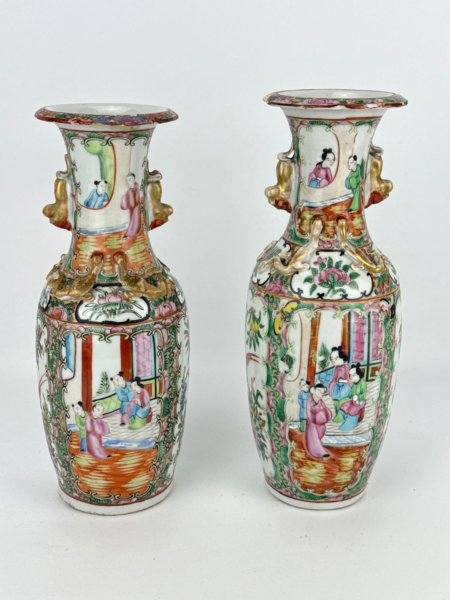 PAIR OF ANTIQUE CHINESE EXPORT ROSE MEDALLION PORCELAIN BALUSTER VASES: A pair of 19th-century Chinese export porcelain baluster-form vases hand-painted in the Rose Medallion pattern with panels of court figures and birds on flowering branches, accented by molded applied 