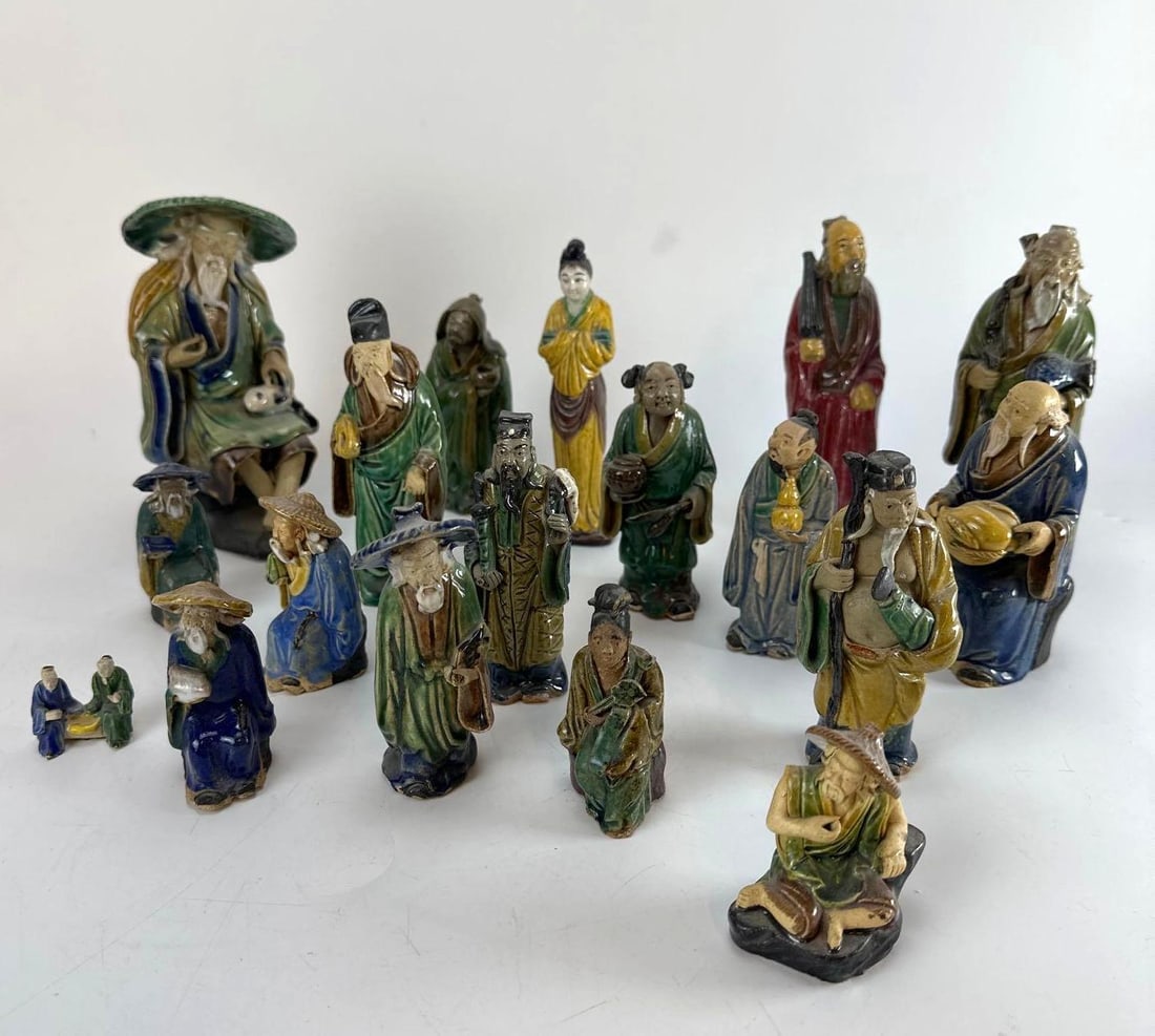 LARGE ASSEMBLED COLLECTION OF EIGHTEEN (18) CHINESE EXPORT SHEKWAN MUD MEN GLAZED POTTERY FIGURES: An assembled collection of eighteen antique and vintage Chinese export Sancai-glazed earthenware "Mud Men" figures depicting various immortal, scholar, and elder motifs with hand-sculpted deta