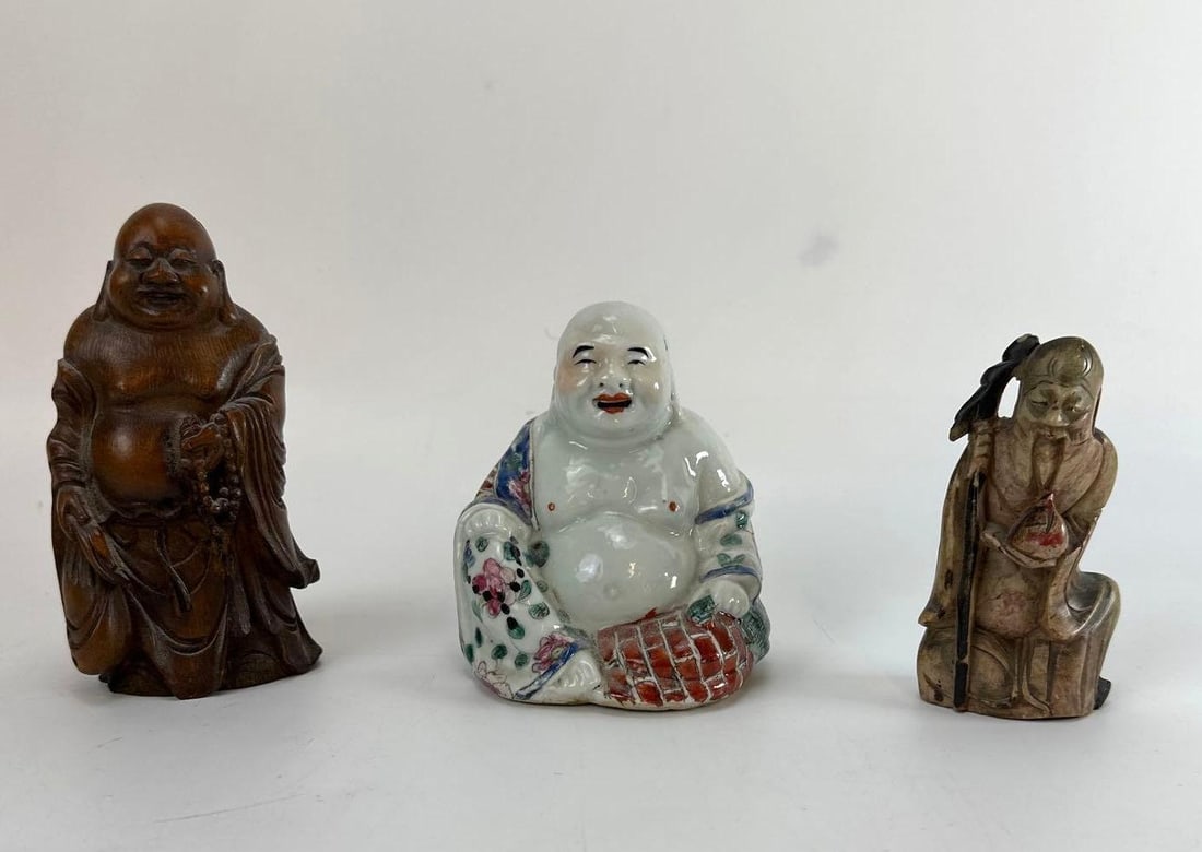 CHINESE PORCELAIN BUDDHA, SOAPSTONE AND WOOD FIGURES LOT OF 3: Group of three small Asian decorative items consisting of a porcelain laughing Buddha, a carved soapstone immortal figure, and a carved wood figure Approximate Dimensions: 5” H Artist or Maker: 