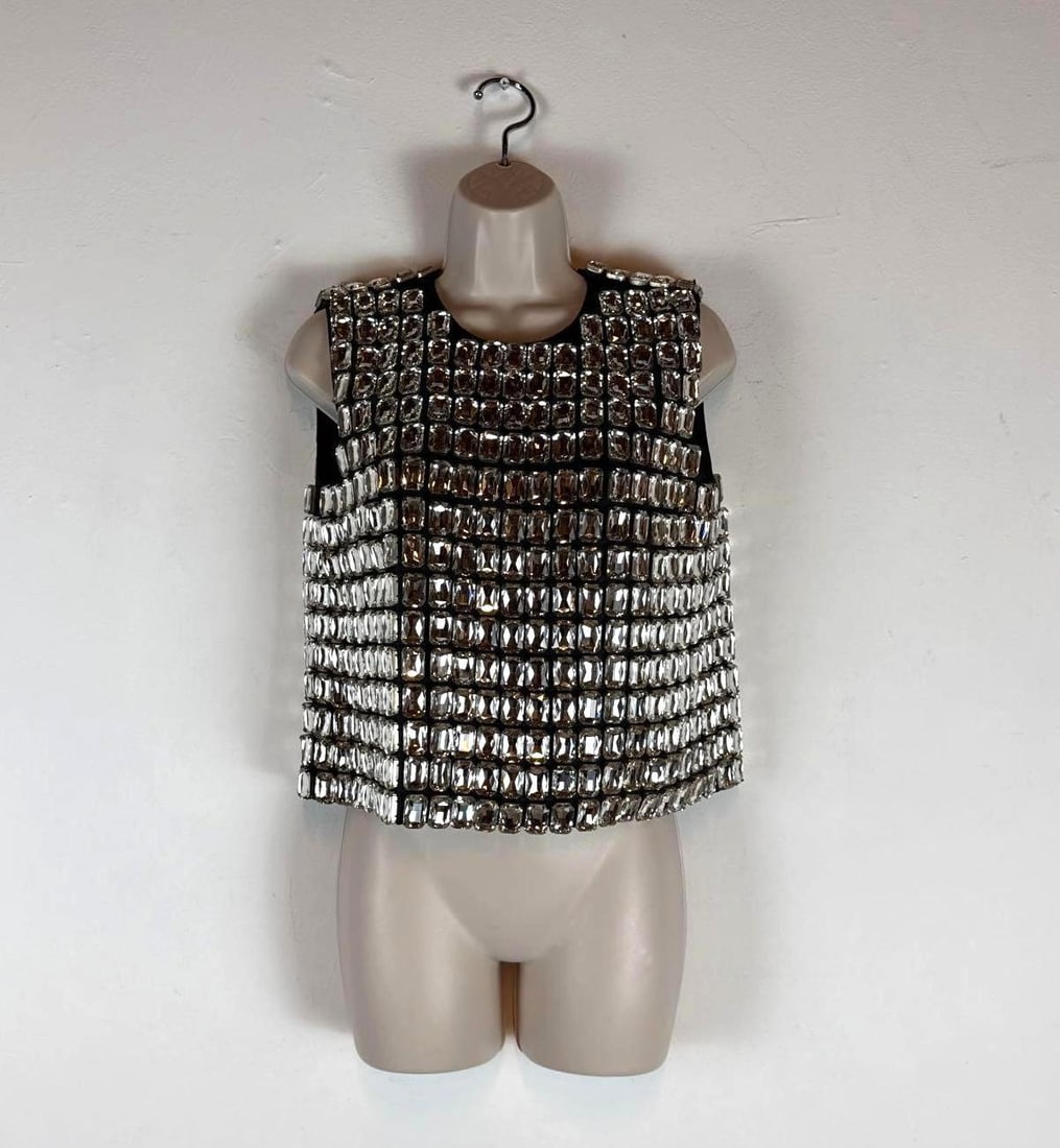 MOSCHINO COUTURE CRYSTAL EMBELLISHED CROPPED BLACK TANK TOP (1 OF 2): A sleeveless crewneck crop top in black, entirely embellished with a grid pattern of large, faceted rectangular glass crystals. Retail: $9,495.00 Measurements: 18” across chest 14” across 