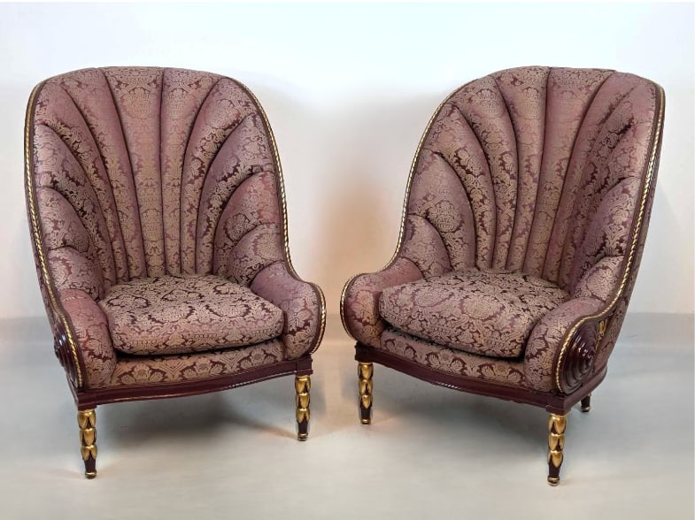 PAIR OF NAUTILUS STYLE ARM CHAIRS IN THE MANNER OF PAUL IRIBE: Pair of Art Deco nautilus style club chairs in the manner of Paul Iribe, showcasing a dramatic fan-shaped channeled shell back upholstered in a damask pattern with carved spiral scroll arm details and