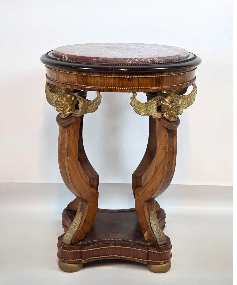 EMPIRE STYLE INLAID BRASS MOUNTED GUERIDON TABLE WITH ROUGE MARBLE TOP: French Empire style round gueridon side table featuring an inset rouge marble top over a finely inlaid frieze, supported by three curved legs adorned with cast brass winged lion or griffin mounts and 