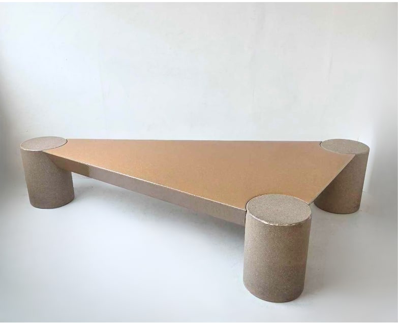 VINTAGE POSTMODERN STYLE FAUX STONE OVERSIZED TRIANGULAR COFFEE TABLE: Vintage postmodern oversized triangular cocktail table with three robust cylinder-form faux stone legs supporting a sleek geometric top. Approximate Dimensions: 15.25"h x 82.25"w x 41"d Ar