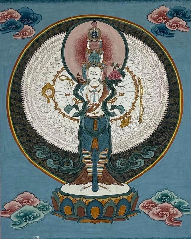 TIBETAN SCHOOL HAND PAINTED THANGKA SAHASRABHUJA AVALOKITESHVARA MANDALA: Hand-painted Tibetan Buddhist thangka depicting the eleven-headed, thousand-armed Avalokiteshvara standing upon a lotus throne. Approximate Dimensions: 18”x24” Artist or Maker: Unknown