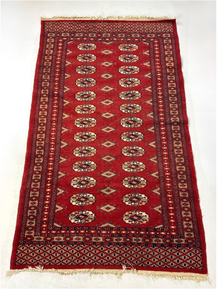 HAND-KNOTTED TURKMEN BOKHARA ORIENTAL AREA RUG: Red hand-knotted wool area rug with geometric gul medallions and multi-layered borders Approximate Dimensions: 37”x54” Artist or Maker: Unknown Provenance: From a New Yor