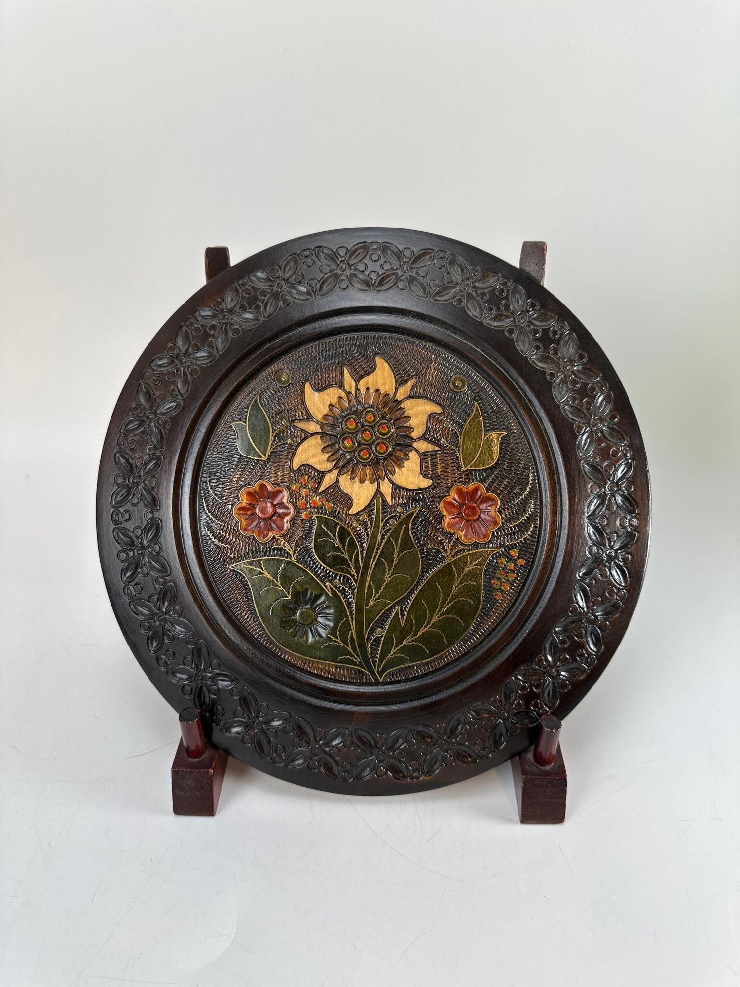 VINTAGE HAND-CARVED WOODEN FRUIT AND FLORAL DECORATIVE WALL PLATE: Vintage round wooden display charger featuring deeply hand-carved low-relief decoration of mixed fruits, leaves, and trailing vines along the rim Approximate Dimensions: 10.5”diameter Artist or 