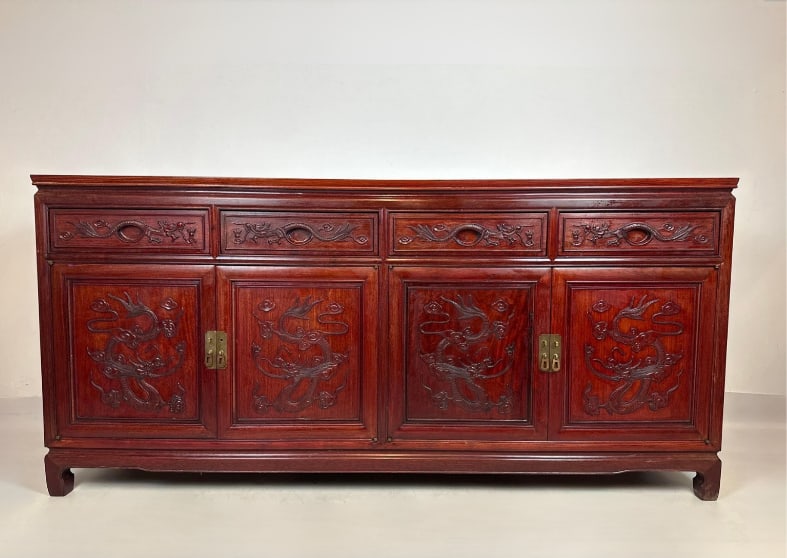 CHINESE EXPORT CARVED ROSEWOOD SIDEBOARD CREDENZA LONG SIDE TABLE: Large 72-inch Chinese rosewood sideboard console table with intricately carved imperial dragon motifs on four cabinet doors and four upper drawers, fitted with traditional brass hardware Approximate D