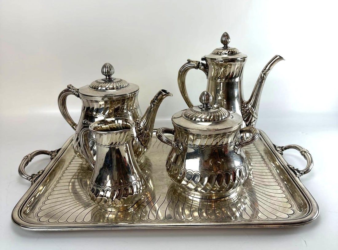 CHRISTOFLE FRENCH SILVER PLATE TEA AND COFFEE SERVICE IN THE TORSADES PATTERN: Five-piece silver plated coffee and tea service in the Art Deco "Torsades" pattern consisting of a coffee pot, teapot, covered sugar bowl, cream pitcher, and dual-handled presentation tray dec