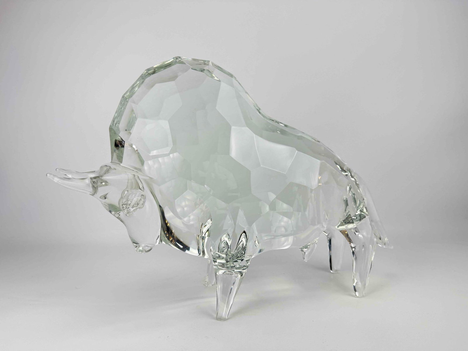 ARNALDO ZANELLA SIGNED MURANO ITALY FACETED LARGE ART GLASS BULL SCULPTURE: Large Italian heavy geometric cut clear glass bull figure with incised signature to base. Approximate Dimensions: 13” H X 18.5” W X 5.5” D Artist or Maker: Arnaldo Zanella Provenance