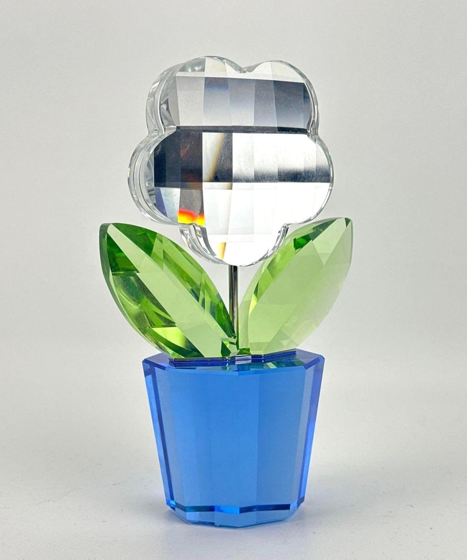 SWAROVSKI CRYSTAL LARGE HAPPY FLOWER COLORED FIGURINE: Whimsical faceted art glass floral sculpture depicting a multi-colored blossom resting in a vibrant base pot, marked with Swan logo to underside Approximate Dimensions: 7”h x 4.5”w x 3&rdq