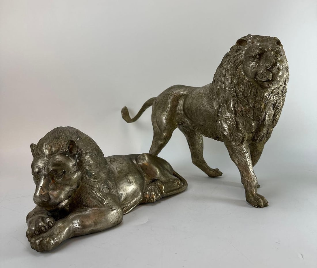 VINTAGE CONTINENTAL STYLE CAST METAL PEWTER FINISH PAIR OF GUARDIAN LION SCULPTURES: Pair of vintage heavy cast metal tabletop lion sculptures with a textured silvery-grey pewter finish. Approximate Dimensions: 16”x5”x11” Artist or Maker: Unknown Provenance: From a N