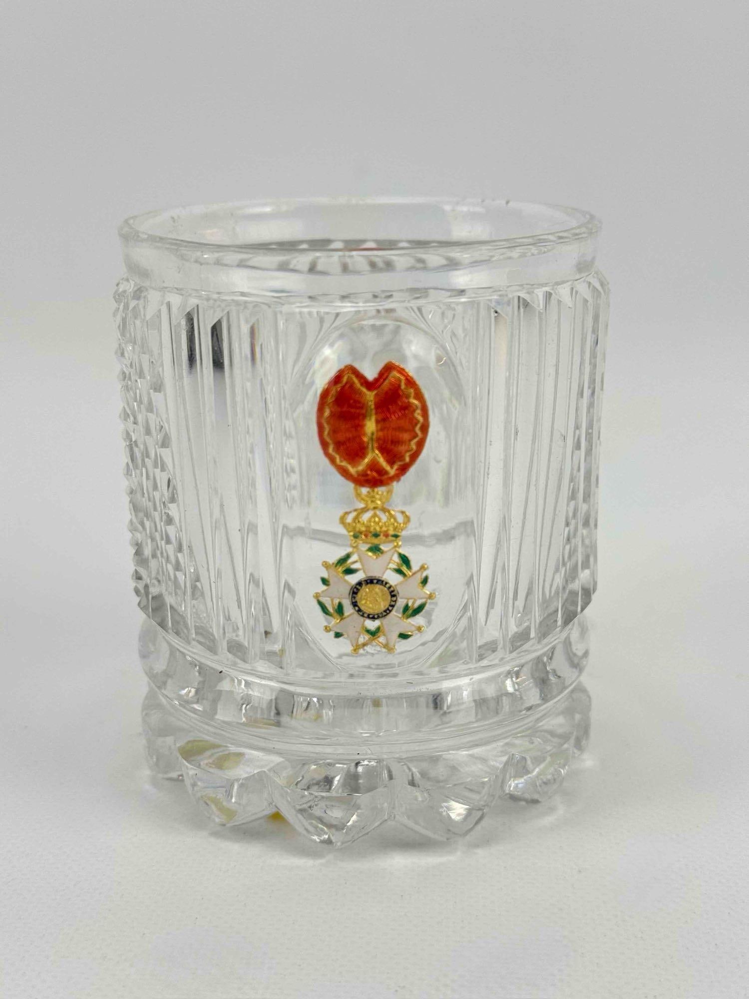 KRUG RARE ANTIQUE CUT GLASS SULPHIDE TUMBLER ENCASING FRENCH LEGION OF HONOR MEDAL: A cut-glass tumbler encasing an enameled metal enclosure of the French Legion of Honor medal. Small chip to base. Approximate Dimensions: 3.5”h x 3”dia Artist or Maker: Krug Provenance: Fr