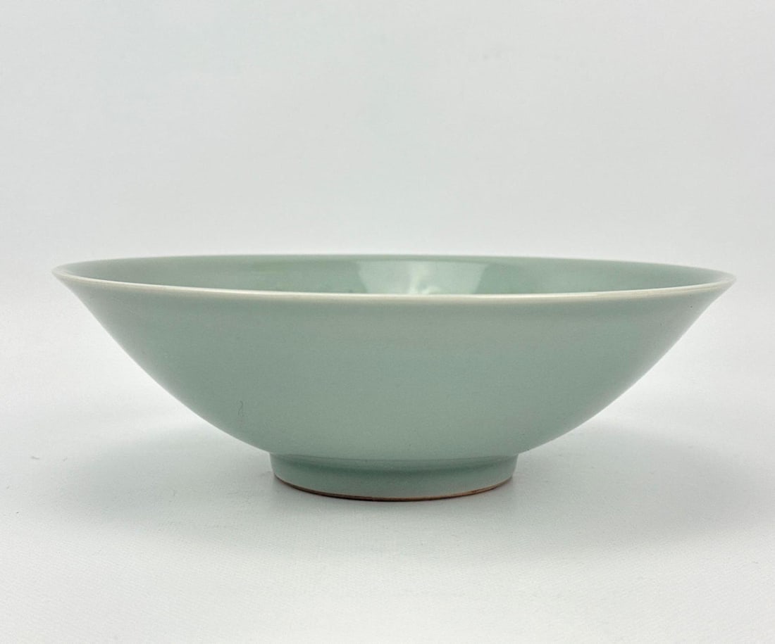 ANTIQUE KOREAN GORYEO STYLE CELADON GLAZED CERAMIC FISH BOWL: *A celadon glazed ceramic bowl with subtly incised or molded interior swimming fish motifs. Approximate Dimensions: 2.5”H x 8.25”Dia Artist or Maker: Unknown Provenance: From a Bridgehampt