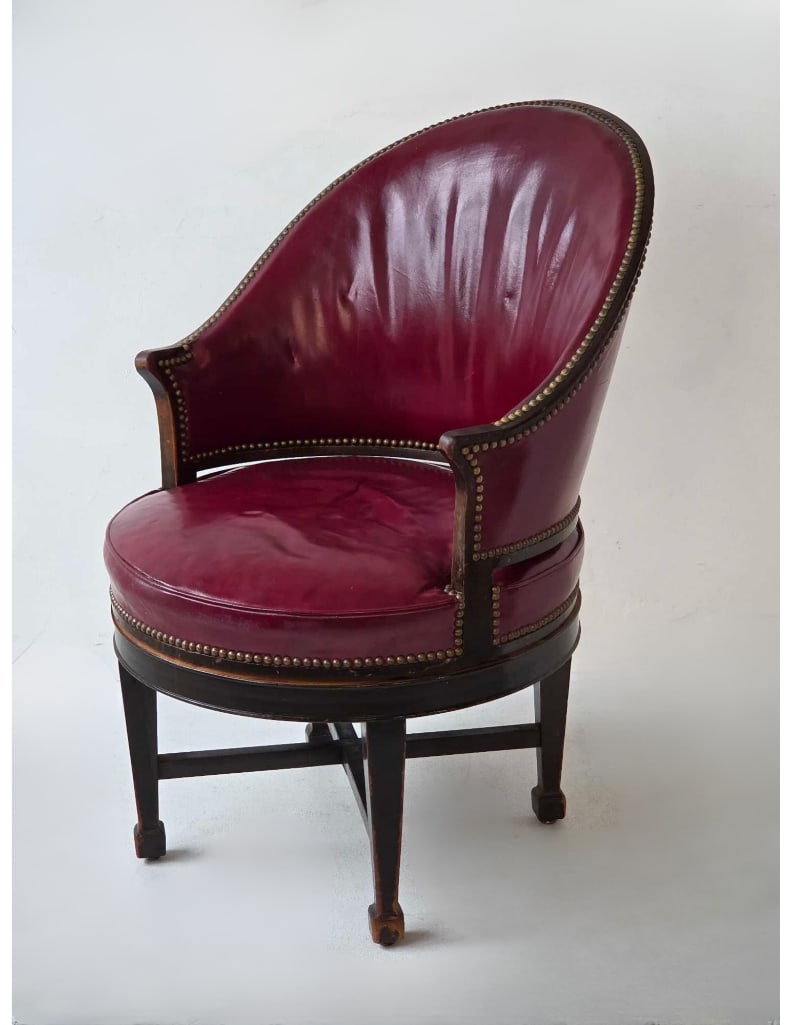 ANTIQUE GEORGIAN STYLE MAHOGANY AND LEATHER SWIVEL LIBRARY ARMCHAIR: Traditional high-backed executive desk or library chair upholstered in tufted oxblood brown leather, trimmed with classic brass nailhead detailing, and set on a rotating mahogany four-star base with f