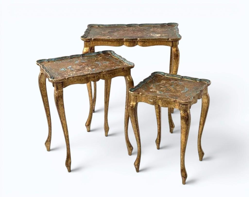 VINTAGE ITALIAN FLORENTINE NESTING TABLES WITH GOLD AND TURQUOISE ACCENTS: A set of three vintage Italian Florentine graduated nesting tables with faded gold gilt surfaces, scalloped tray-style tops with hand-painted turquoise and polychrome accents, and slender cabriole leg