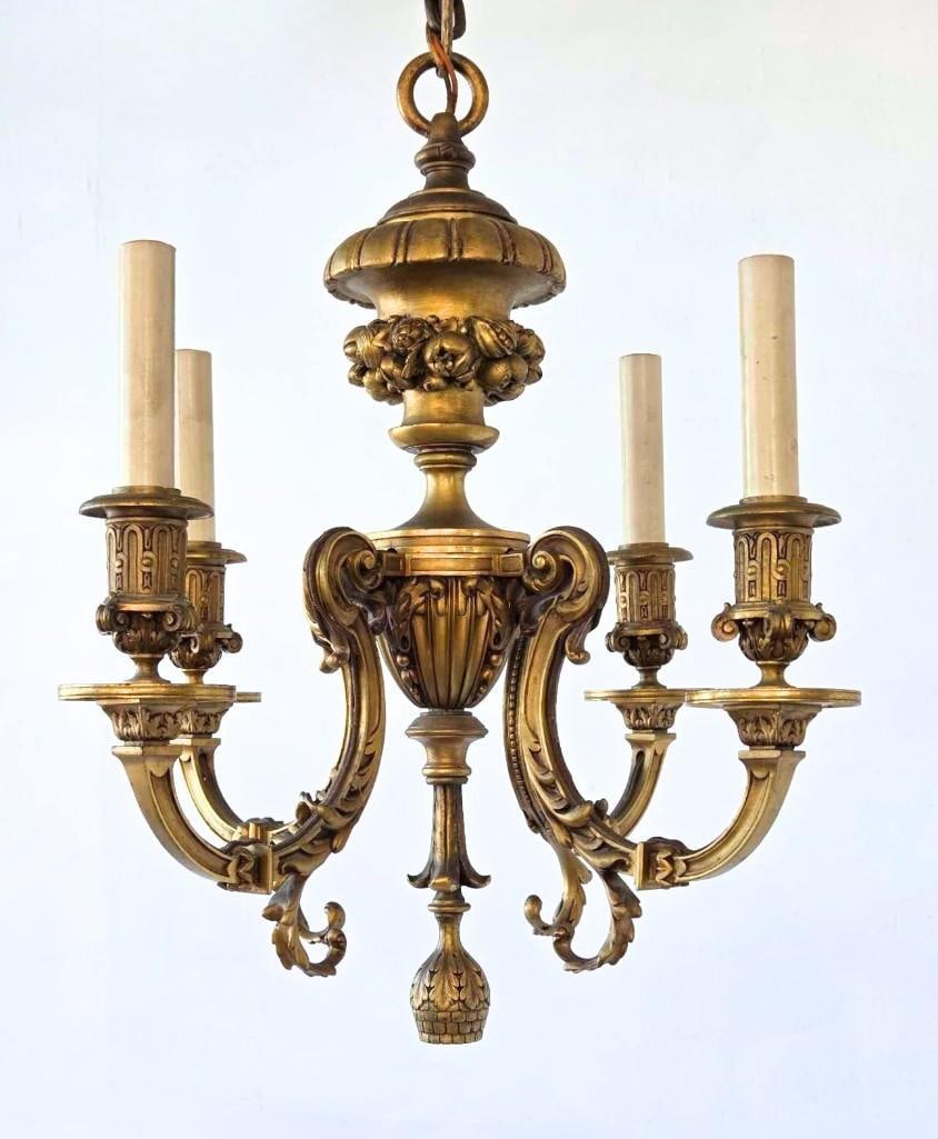 ANTIQUE FRENCH ROCOCO STYLE GILT BRONZE FOUR LIGHT CHANDELIER: Ornate 19th-century dore gilt bronze four-arm ceiling light fixture showcasing scrolling acanthus leaf branches, floral bobeches, and a central cast foliate baluster stem. Approximate Dimensions: 18&#
