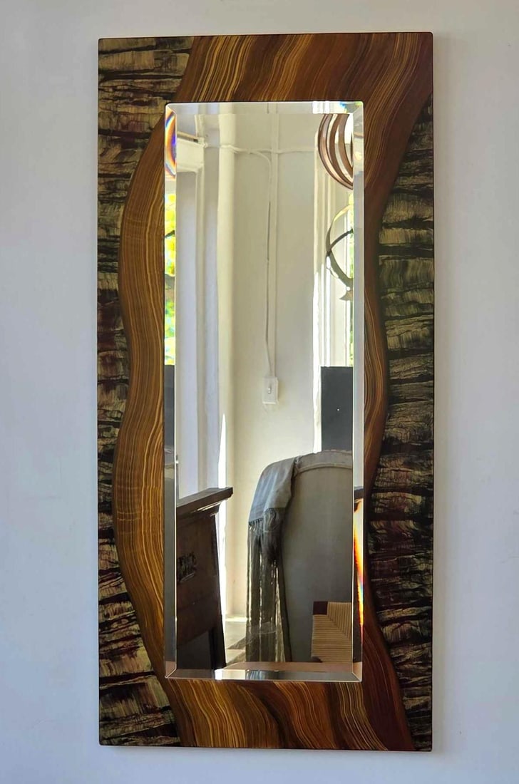 GRANT NOREN SIGNED CONTEMPORARY FAUX BOIS WOOD GRAIN WALL MIRROR: Rectangular bevel plate glass mirror bordered by a custom hand painted multi-toned simulated organic wood veneer frame with an incised signature to reverse. Approximate Dimensions: 41.5" x 19.5