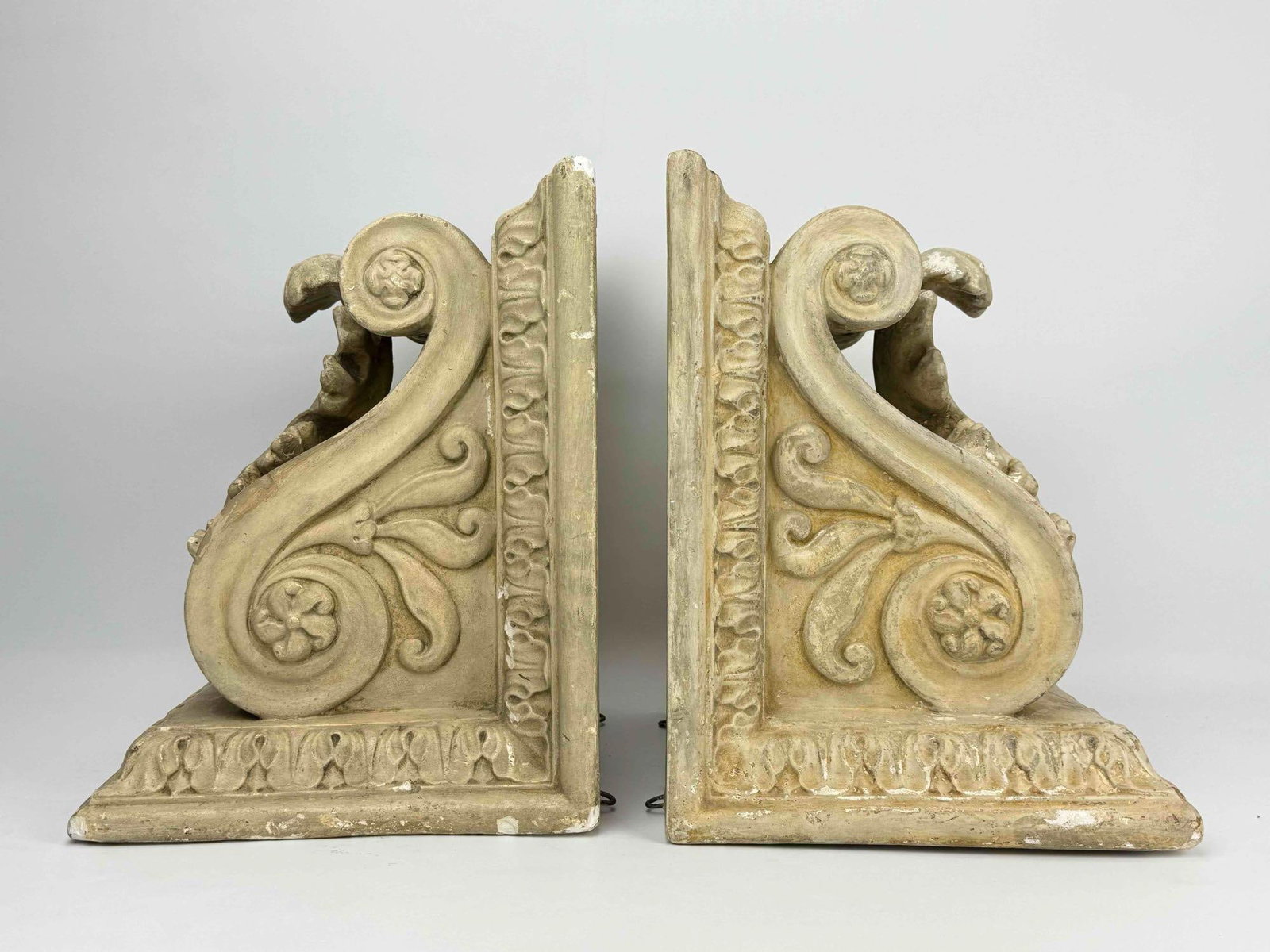 LARGE PAIR OF VINTAGE MAITLAND SMITH STYLE PLASTER ARCHITECTURAL CORBELS: *Pair of large neoclassical style patinated composite structural brackets molded with outspread acanthus leaf decorations, heavy side scrolls, and stylized egg and dart borders. Approximate Dimensions