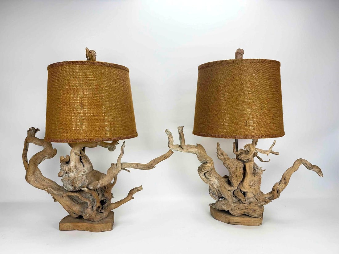 PAIR OF VINTAGE DRIFTWOOD TABLE LAMPS: A pair of mid-century, organic sculptural natural driftwood table lamps with textured burlap drum shades. Approximate Dimensions: 29”H x 26”W x 22.5”Dia Artist or Maker: Unknown Prov