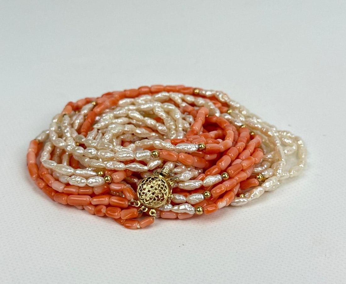 VINTAGE 14K GOLD MULTI-STRAND ANGEL SKIN CORAL AND FRESHWATER PEARL NECKLACE: A continuous multi-strand necklace composed of alternating sections of salmon pink angel skin coral cylinder beads and creamy white freshwater keshi pearls punctuated by small gold spacer beads, compl
