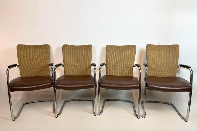 SET OF 4 VINTAGE HAWORTH CHROME CANTILEVER ARMCHAIRS MID-CENTURY MODERN STYLE: Set of four tubular chrome cantilever armchairs with brown vinyl seats and textured tan fabric backrests Approximate Dimensions: 21”x21”x36” Artist or Maker: Unknown
