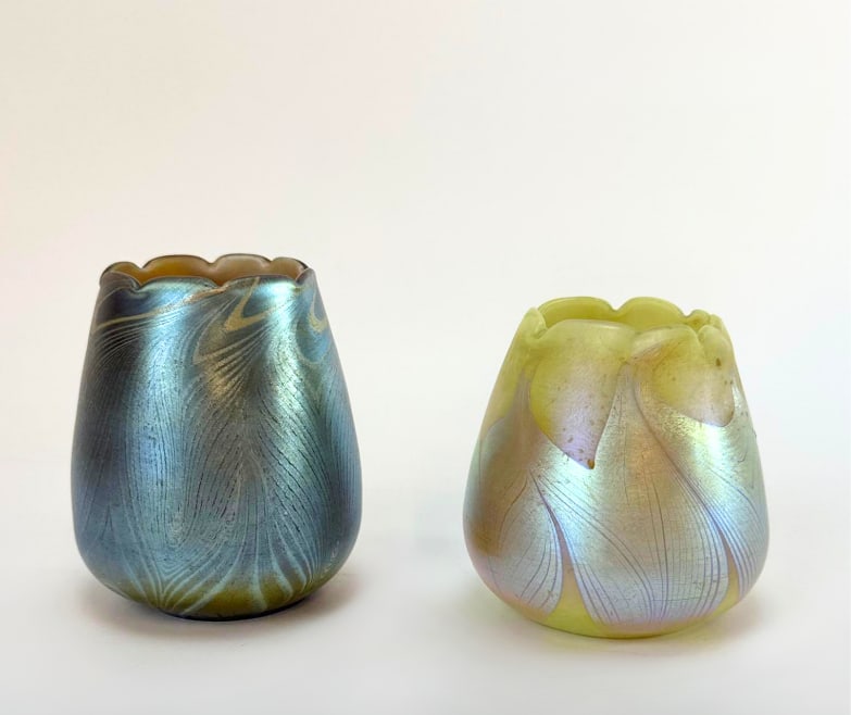 PAIR OF TIFFANY STUDIOS STYLE IRIDESCENT ART NOUVEAU TULIP LAMP SHADES: Two small iridescent blown art glass shades in a scalloped tulip form with wavy pulled patterns in the style of Leotz or Tiffany Studios Favrile. Approximate Dimensions: 2.5”diameter x 3” 