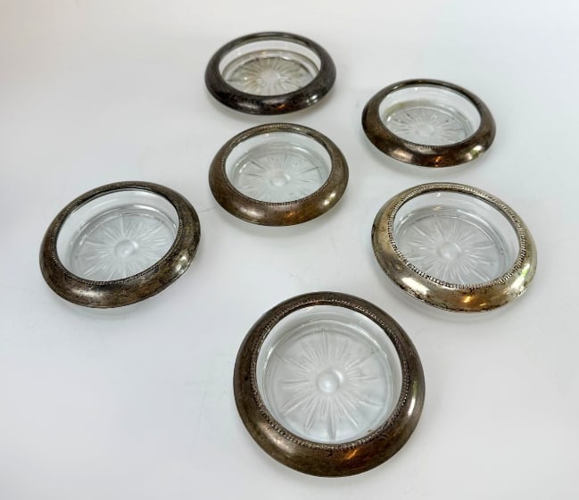 SET OF 6 VINTAGE STERLING SILVER AND CUT GLASS DRINK COASTERS: Six vintage round beverage coasters with starburst-cut glass bases and beaded sterling silver rims Approximate Dimensions: 4”diameter and 3.5”