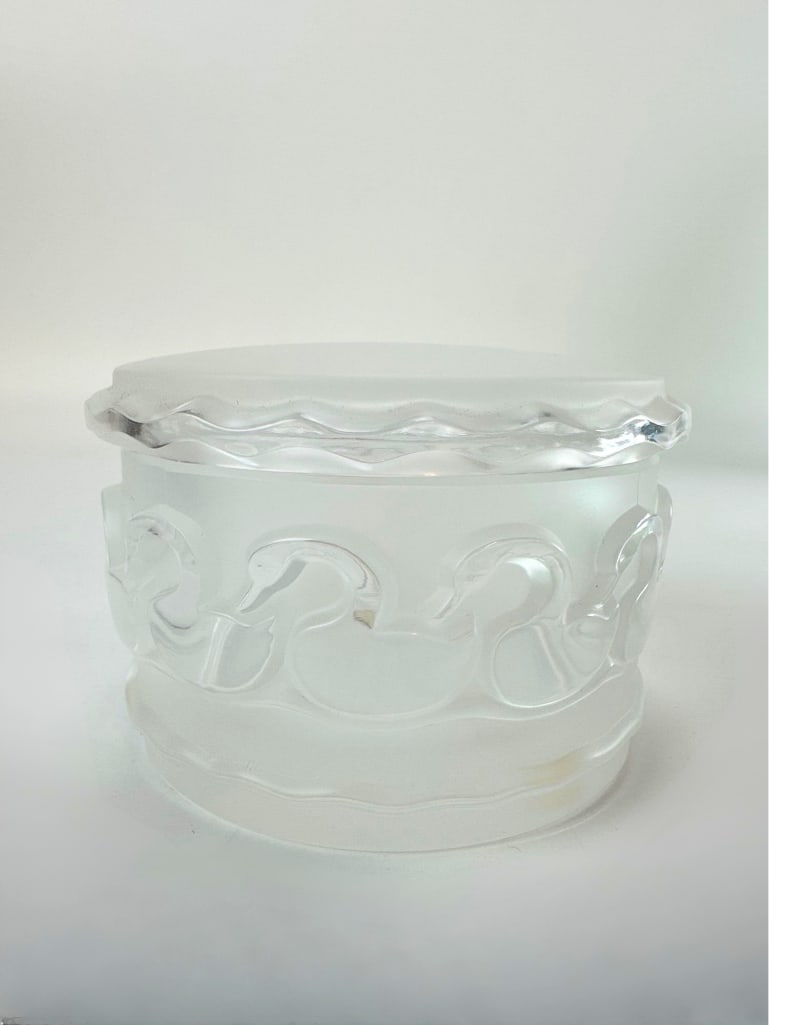 VINTAGE LALIQUE STYLE FRENCH FROSTED GLASS SWAN TRINKET BOX: Circular frosted and clear art glass vanity lidded jar with a molded relief band of swimming swans Approximate Dimensions: 4”diameter x 2.75”tall Artist or Maker: Unknown