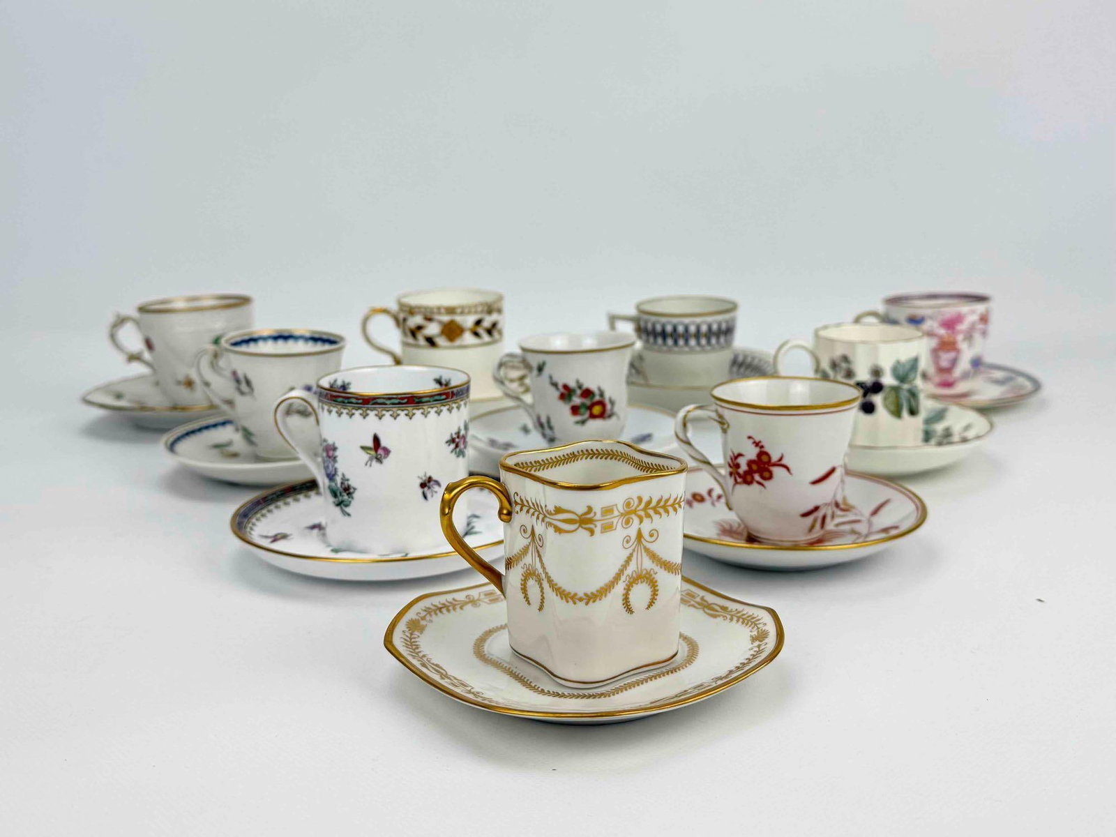 COLLECTION OF TEN (10) ASSORTED GINORI ROYAL WORCESTER SPODE MINIATURE DEMITASSE TEACUPS SAUCERS: Curated lot of ten vintage English and Italian miniature porcelain demitasse cups - teacups with matching saucers with varied hand-painted floral motifs, glazes, and gilt rims. Approximate Dimensions: