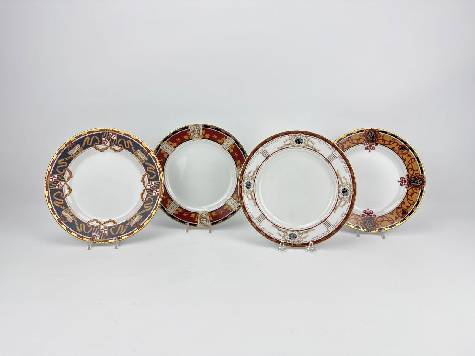 SET OF 4 UNIVERSITY OF MARYLAND TIFFANY & CO. PORCELAIN COLLECTOR PLATES: Set of four vintage Tiffany & Co. bone china collector plates issued for University of Maryland societies with custom collegiate borders and historical text on reverse Approximate Dimensions: .75&