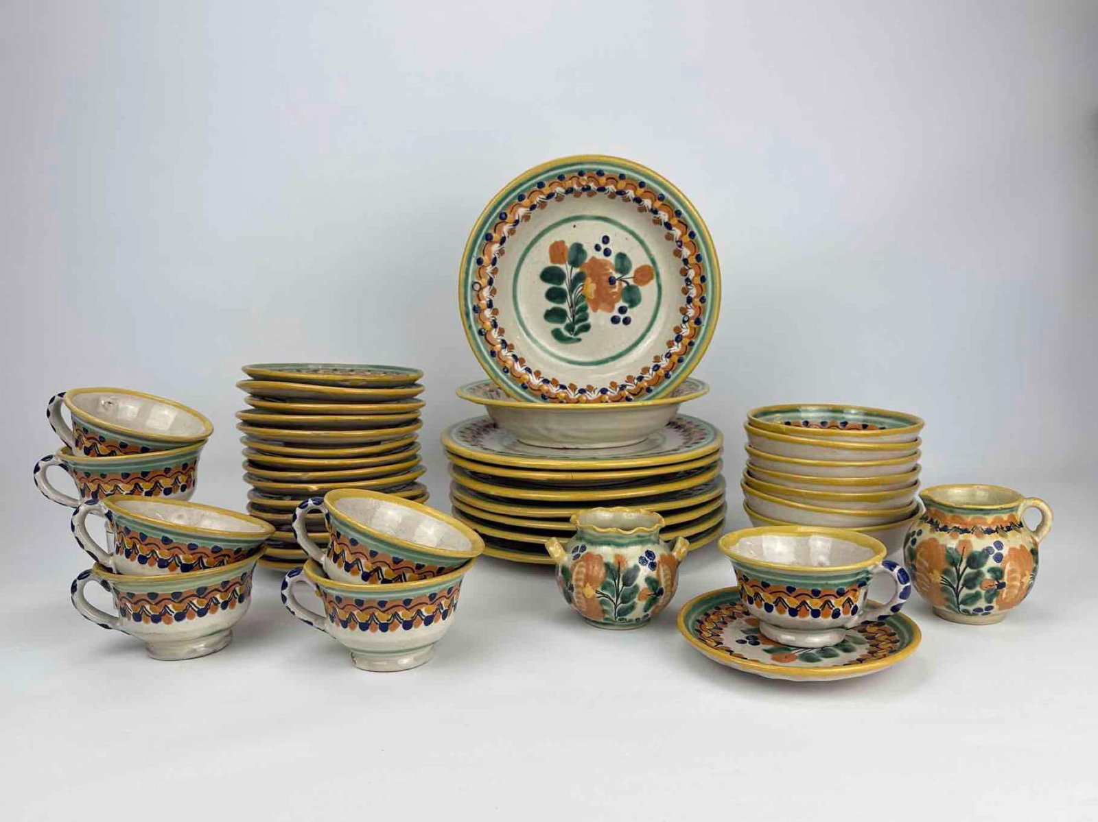 VINTAGE HAND PAINTED MEXICAN TALAVERA CERAMIC FORTY PIECE DINNERWARE SET: Vintage Mexican Talavera glazed earthenware partial dinner and tea service. Approximate Dimensions: 10.25" Dia. X 1.75" H Plate x 7 8.75" Dia. X 1.5" H x Bowl x 2 5.5" Dia. X .5