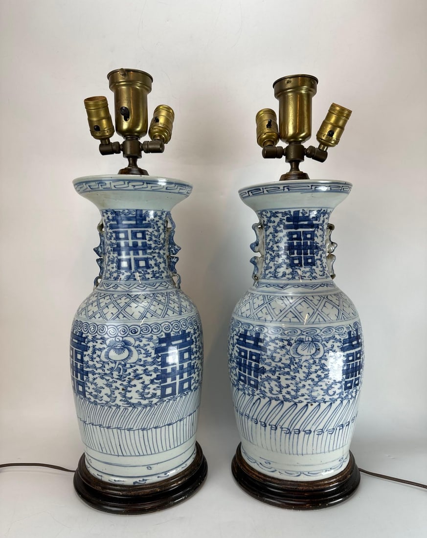 PAIR OF VINTAGE CHINESE BLUE AND WHITE DOUBLE HAPPINESS PORCELAIN VASES MOUNTED AS LAMPS: Pair of vintage Chinese blue and white porcelain table lamps fashioned from traditional baluster jar jars decorated with hand-painted stylized sweet pea scrolling vines and central Shou "Double Ha