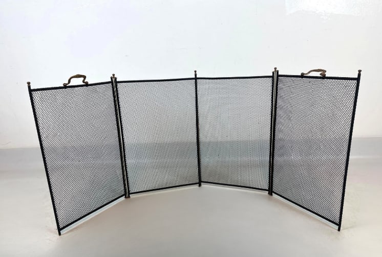 WM. H. JACKSON STYLE FOUR-PANEL FOLDING MESH FIREPLACE SCREEN: A four-panel folding hearth spark guard with woven black wire mesh panels, ball finials, and dual cast brass top carrying handles. Approximate Dimensions: 52” x 19.5” Artist or Maker: Unkn