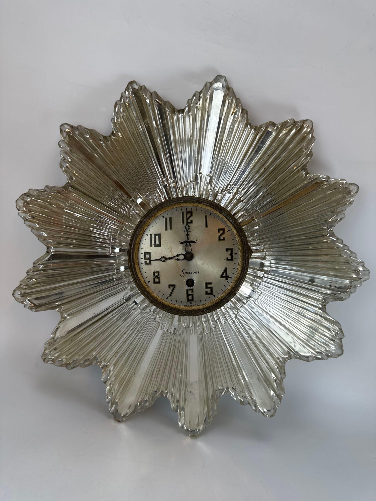 VINTAGE SESSIONS ART DECO STARBURST MIRRORED GLASS WALL CLOCK: Vintage mid-20th century Art Deco style starburst wall clock manufactured by the Sessions Clock Company, featuring a central round brass-bezeled dial with Arabic numerals, surrounded by an architectur