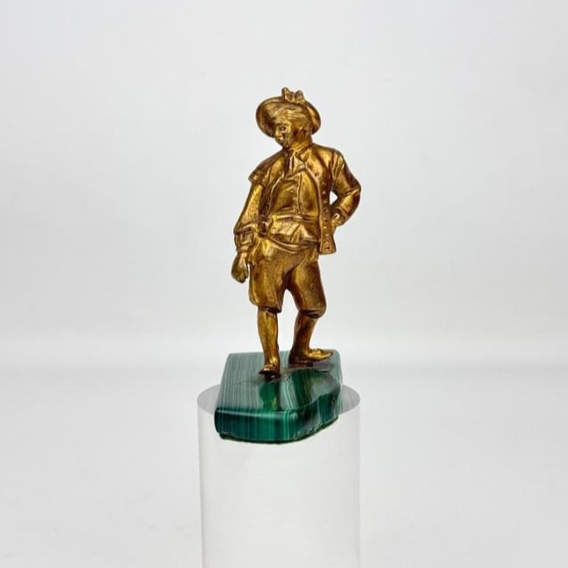 ANTIQUE RUSSIAN OR EUROPEAN GILT BRONZE BOY ON MALACHITE BASE: Antique 19th-century or early 20th-century small cast bronze figural sculpture featuring a finely detailed young boy or page in traditional European court attire, finished in a bright gold d'ore or