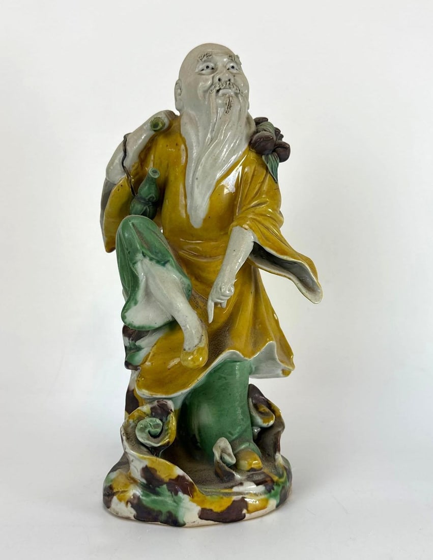 CHINESE BISCUIT PORCELAIN FIGURINE OF DONGFANG SHUO: Chinese molded polychrome biscuit porcelain figurative statue depicting the Daoist immortal Dongfang Shuo Approximate Dimensions: 4”x4”x10” Artist or Maker: Unknown