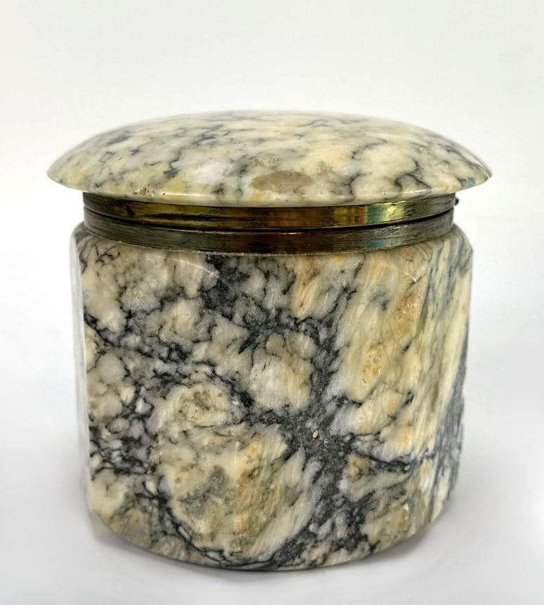 ITALIAN MARBLE HINGED TRINKET BOX WITH BRASS MOUNTS: A heavily-veined marble dresser box with brass rim and a hinged domed lid. Approximate Dimensions: 4"H x 5"Dia Artist or Maker: Unknown Provenance: A New York Collector Notes: Altho