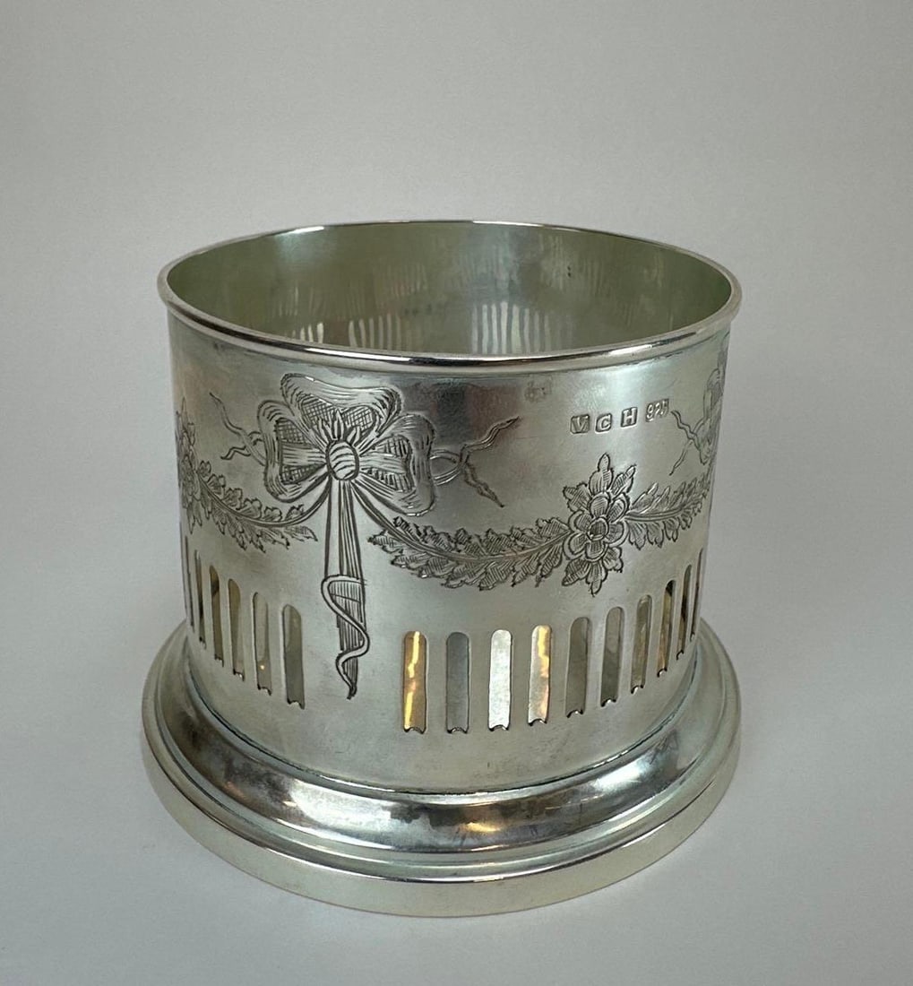 STERLING SILVER PIERCED WINE BOTTLE HOLDER COASTER, STAMPED VCH, 7.3 OZT: Pierced and engraved sterling silver wine bottle coaster with neoclassical festoon and swag decoration, weighing 7.3 troy ounces, as shown in images. Approximate Dimensions: 3.5” H x 5” Di