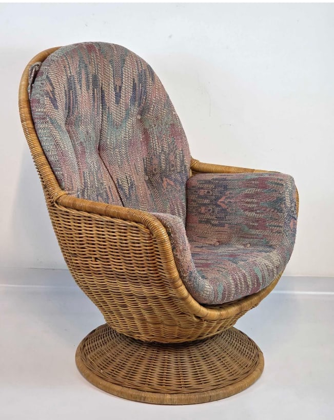 VINTAGE BOHEMIAN WICKER SWIVEL EGG LOUNGE CHAIR: Woven rattan scoop-form pod chair rotating on a matching conical pedestal base outfitted with a thick removable pastel ikat patterned fabric cushion Approximate Dimensions: 41.5" H X 30" W X 3