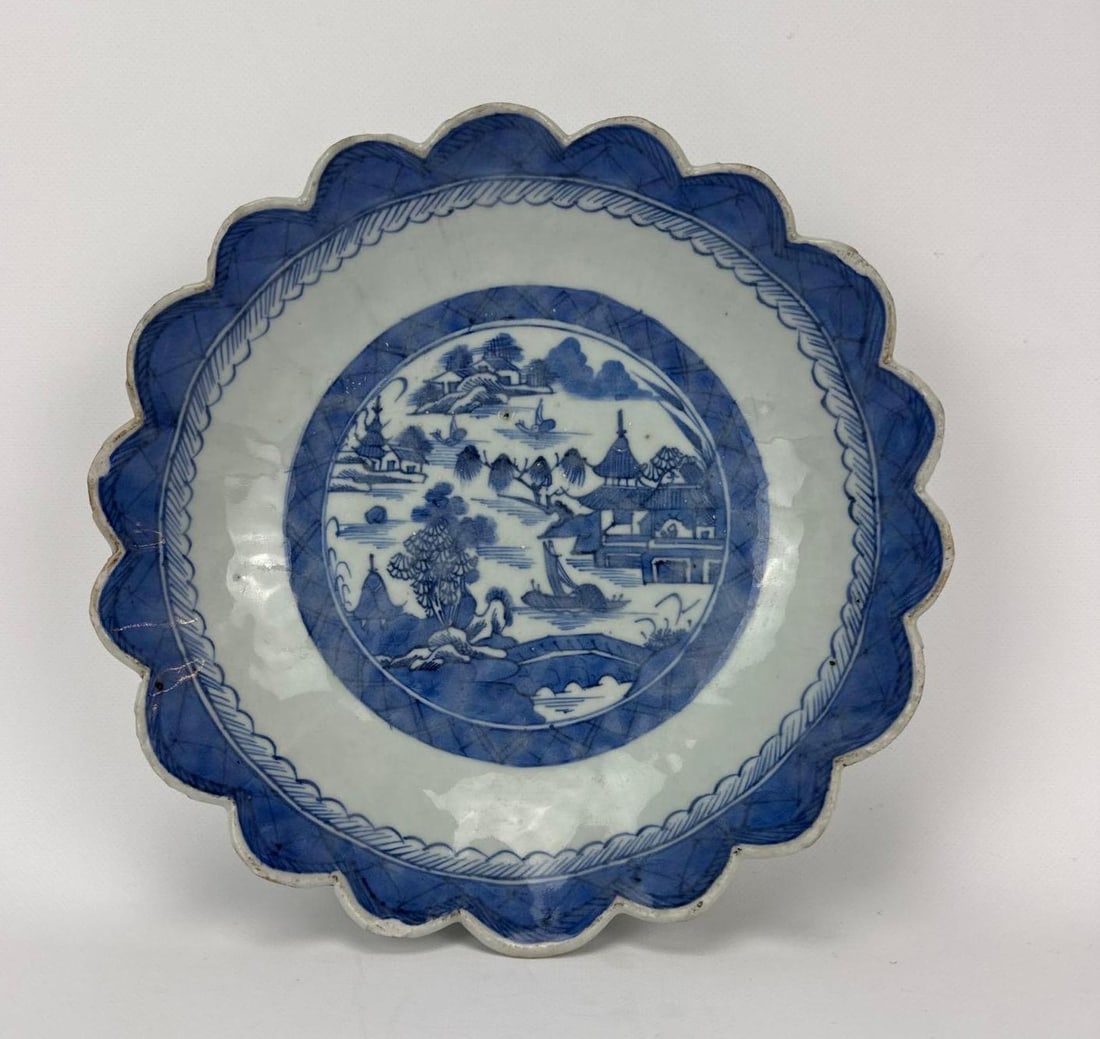 19TH-C CHINESE EXPORT BLUE CANTON PORCELAIN SCALLOPED DISH: Antique underglaze blue and white Chinoiserie landscape patterned circular bowl featuring a heavily lobed fluted rim. Approximate Dimensions: 8.5” x 2" Artist or Maker: Unknown